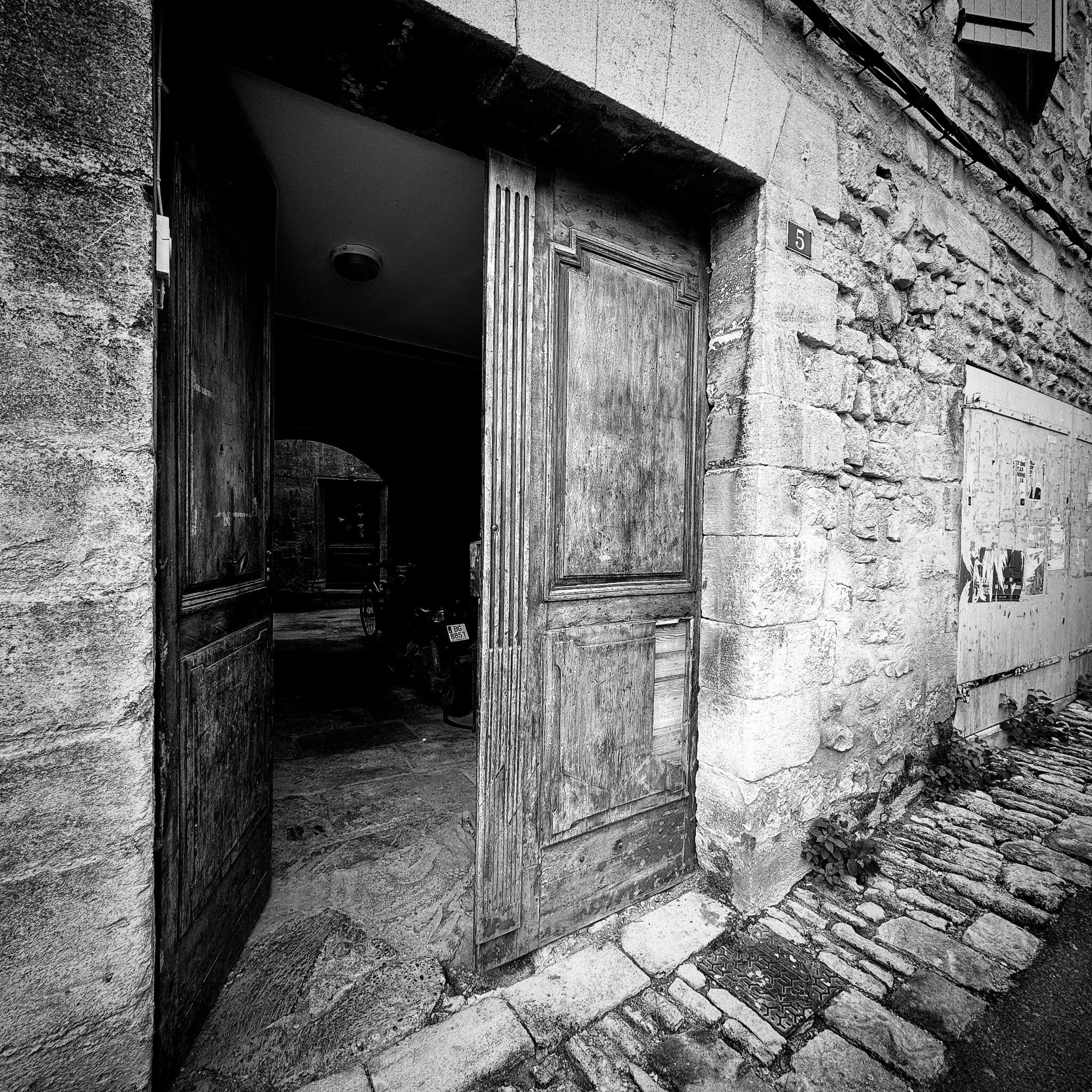 An open doorway casting light into a dark room